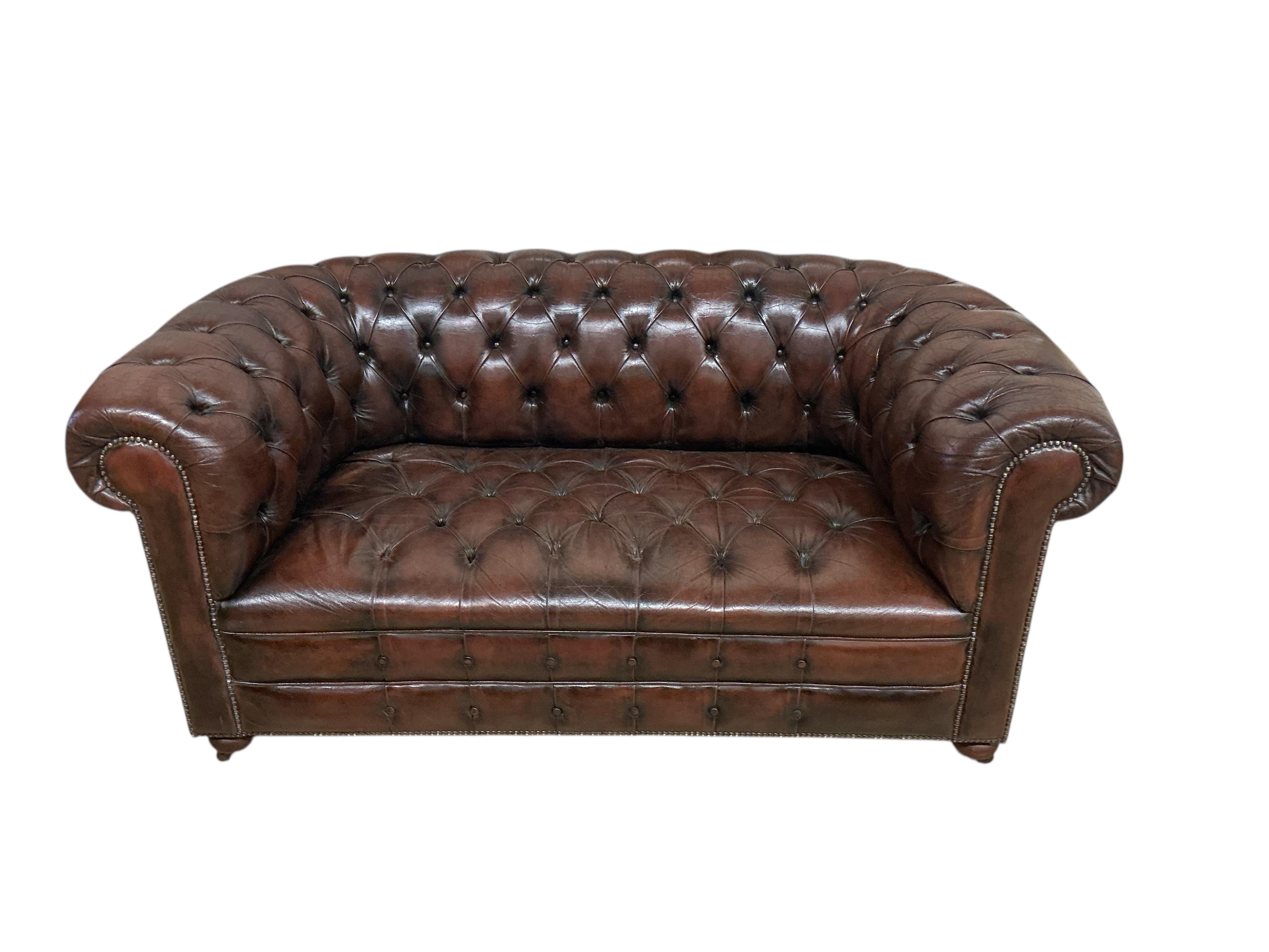 A Victorian style buttoned brown leather Chesterfield settee, width 170cm, depth 84cm, height 76cm